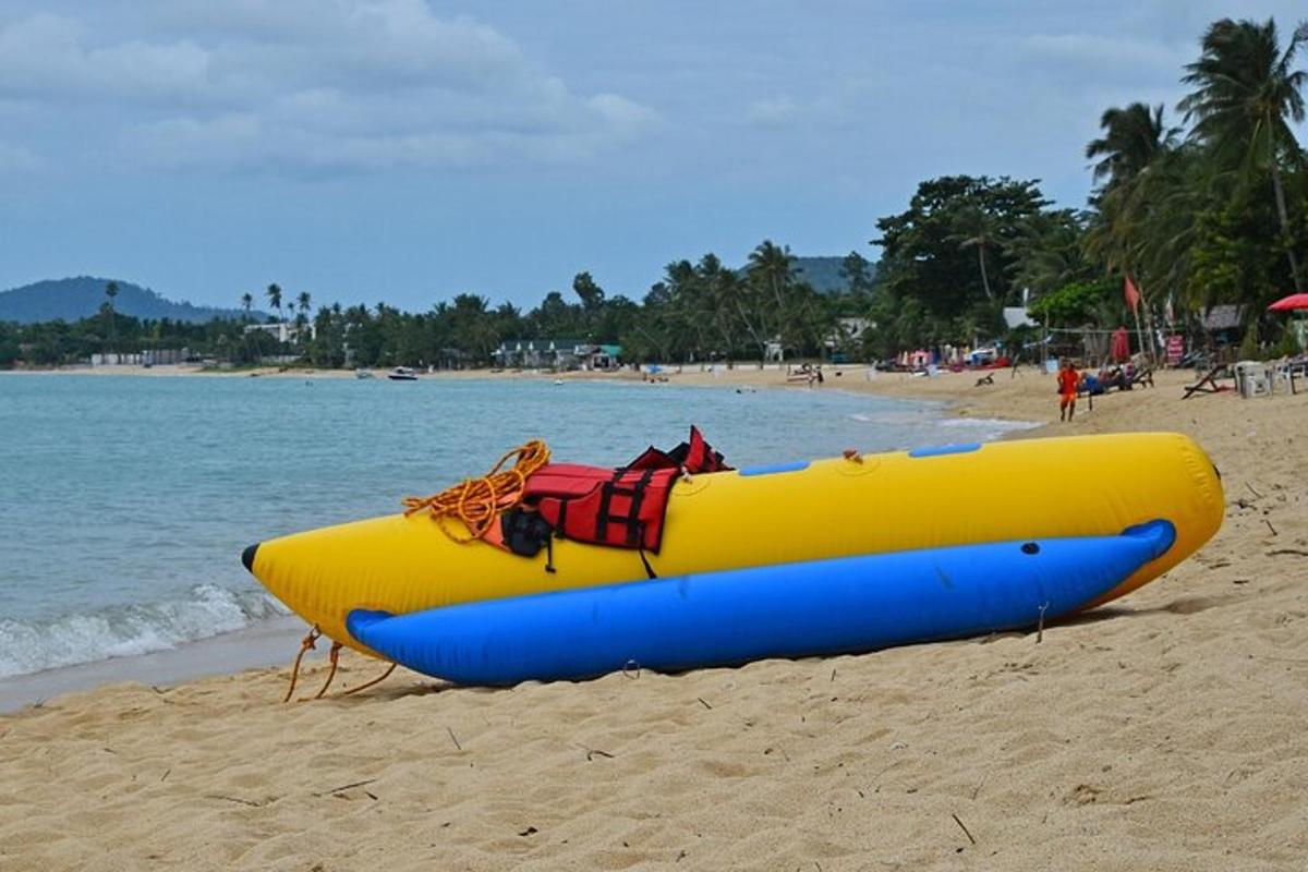 a yellow and blue raft sitting on a beach