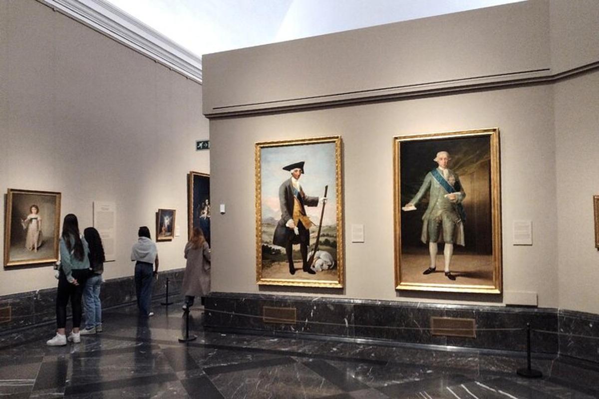 a group of people looking at paintings in a museum