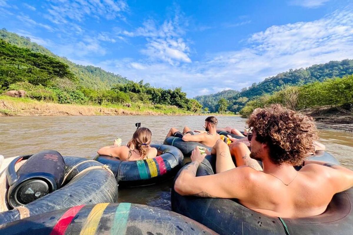 a group of people riding on tubes in the river