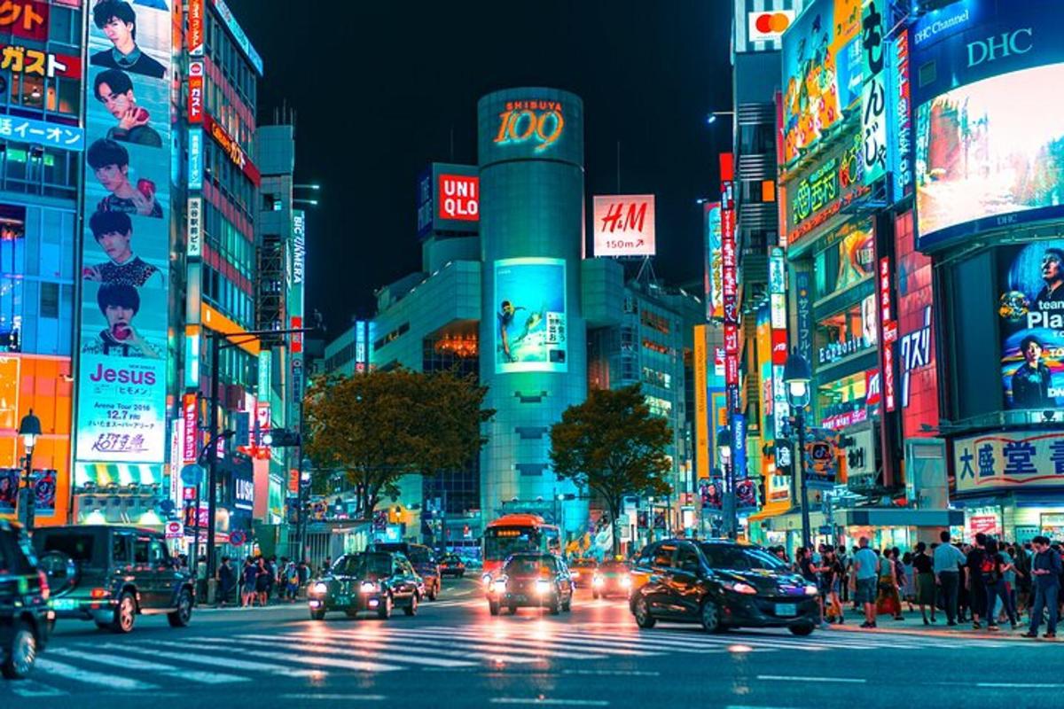 a busy city street at night with cars and buildings