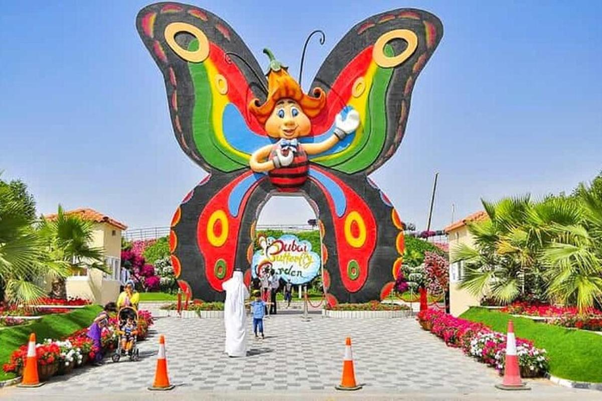 a large butterfly statue in the middle of a park