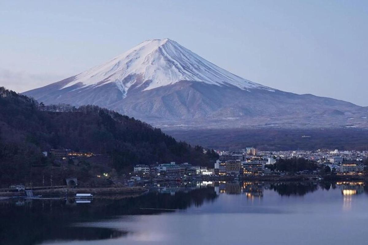 a mountain with a view of a city and a lake