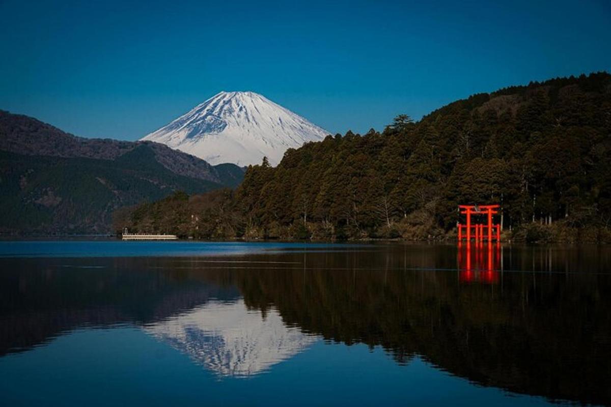a mountain with a red gate in the middle of a lake
