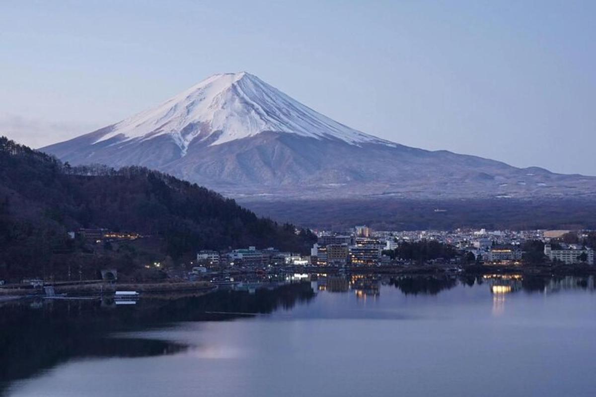 a mountain with a view of a city and a lake
