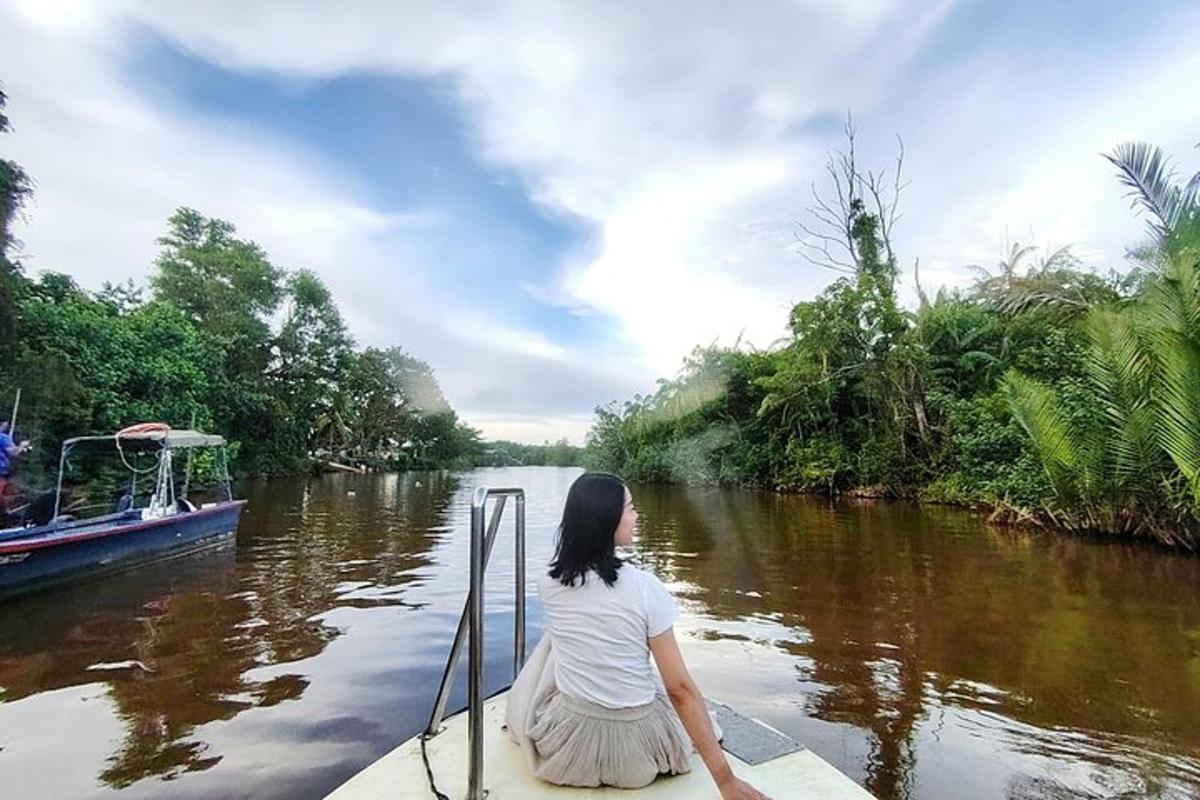 a woman is sitting on a boat on a river