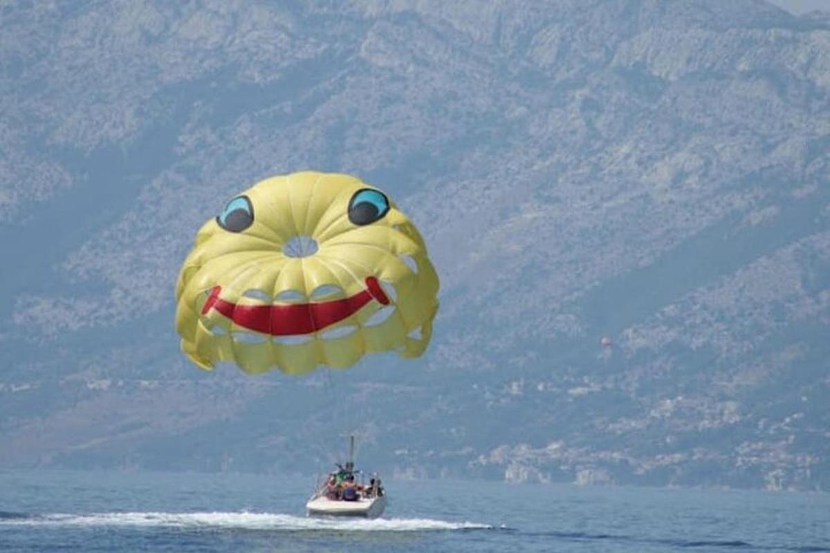 a large kite flying over a boat in the water
