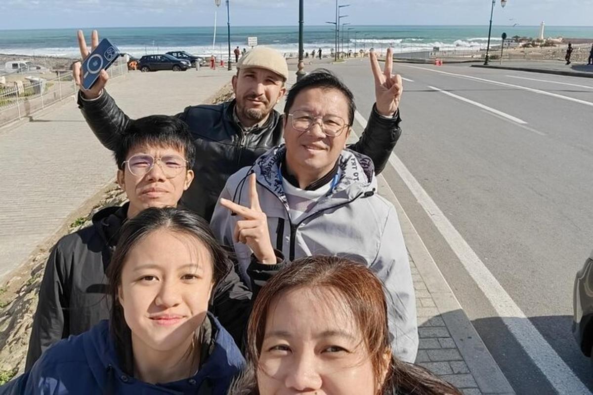 a group of people posing for a picture on the beach