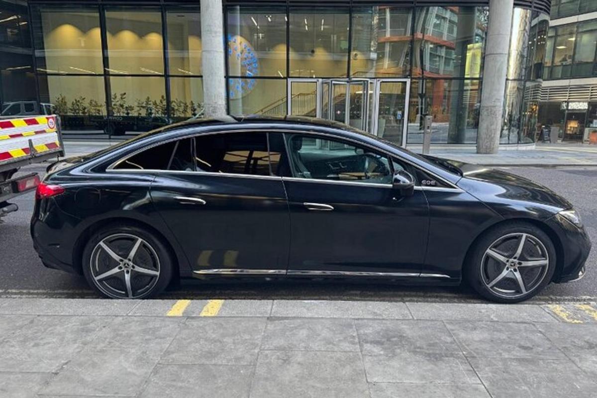 a black car parked on the side of a street