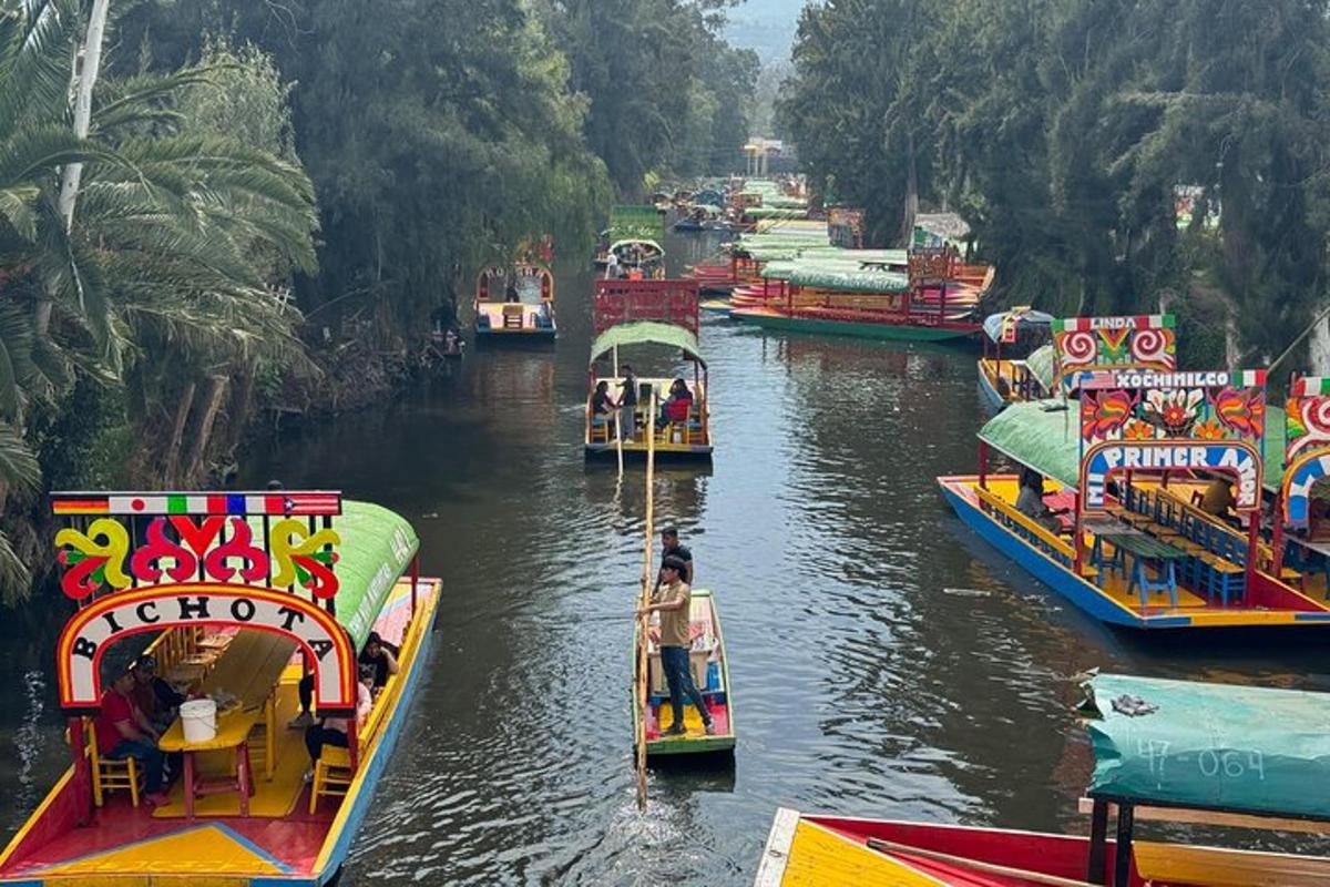 a group of boats in a river with people on them