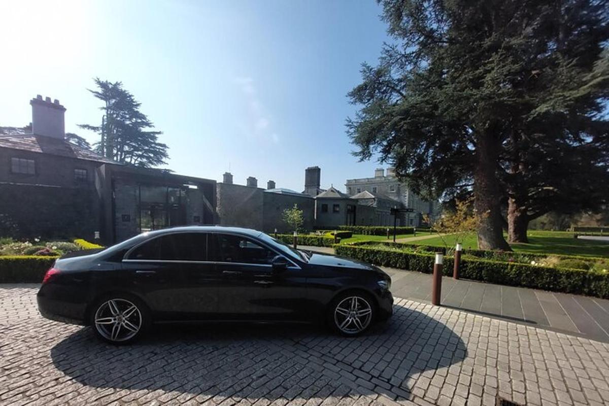 a black car parked on a brick driveway