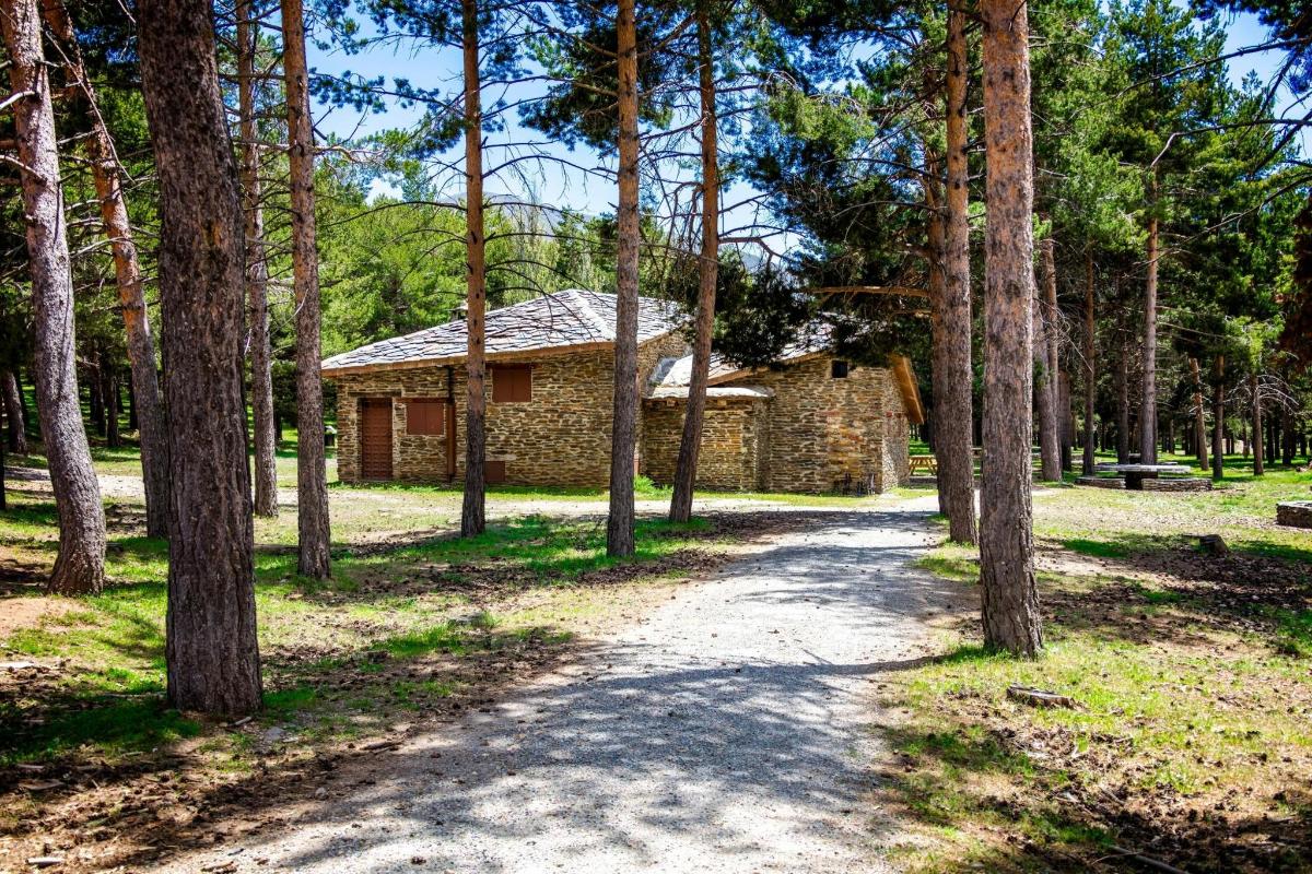 a stone house in the middle of a forest