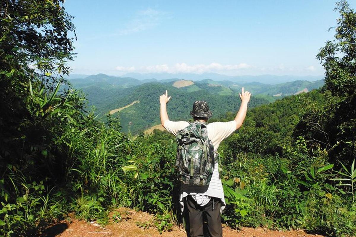 a person with a backpack standing on top of a mountain
