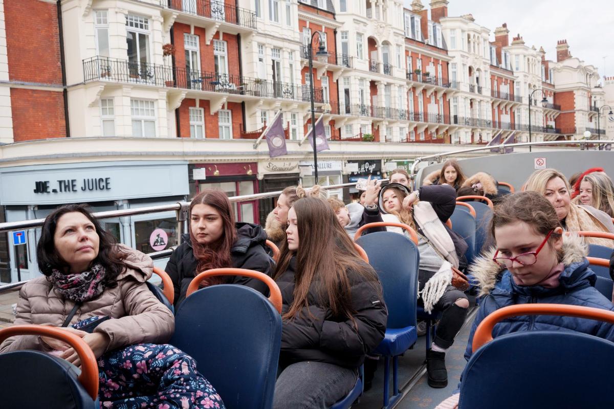 a group of people sitting on a bus