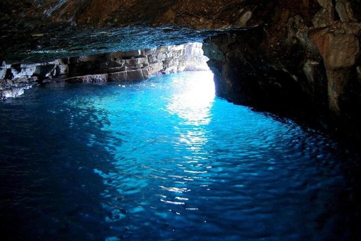 a blue pool of water in a cave