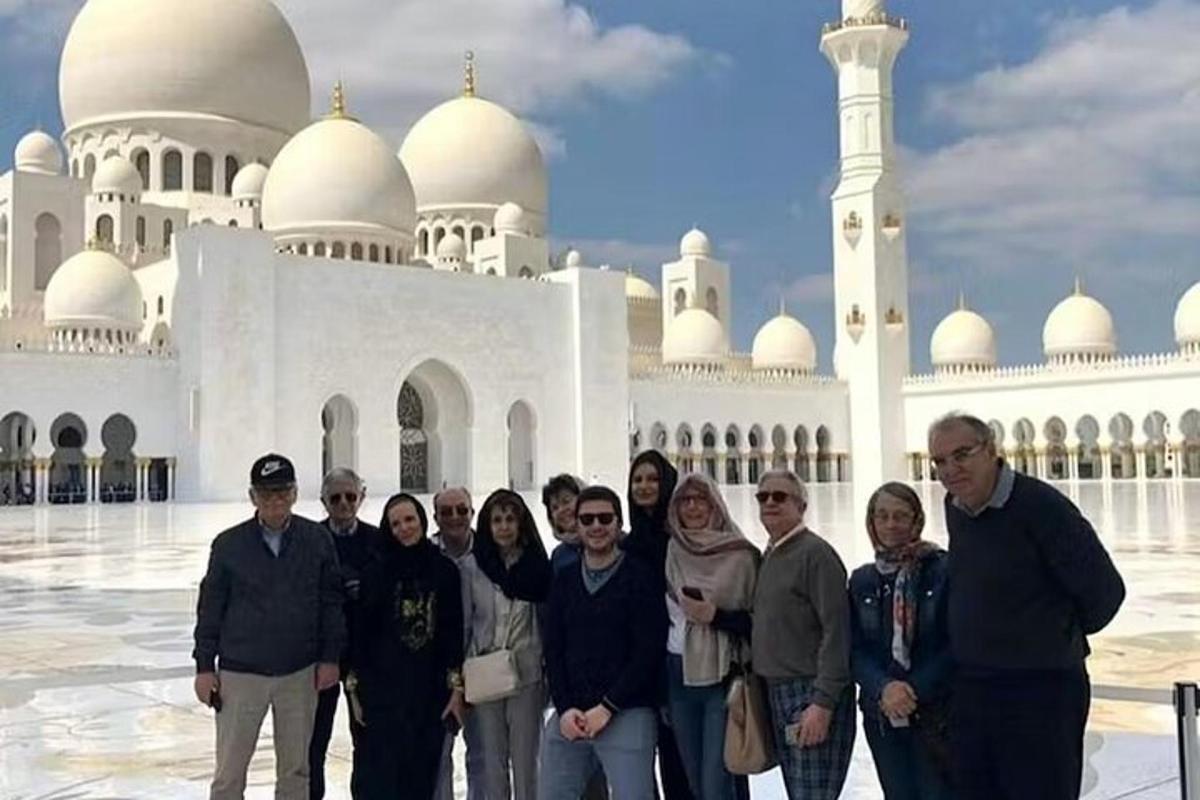 a group of people standing in front of a mosque