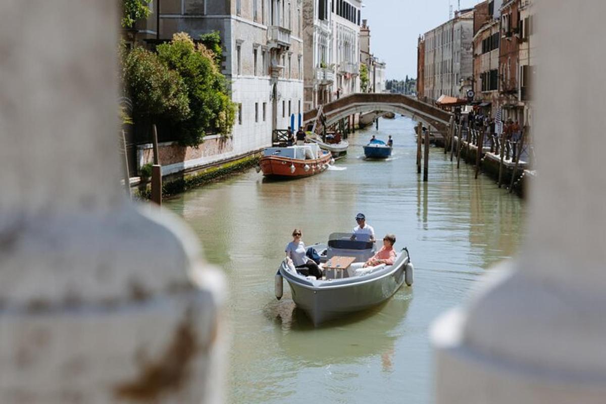 a group of people in a boat on a canal