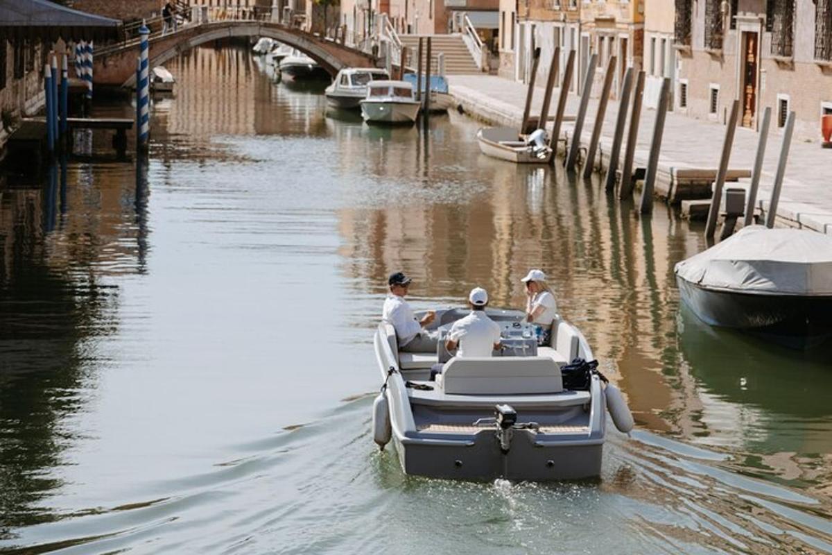 two people in a small boat in a canal