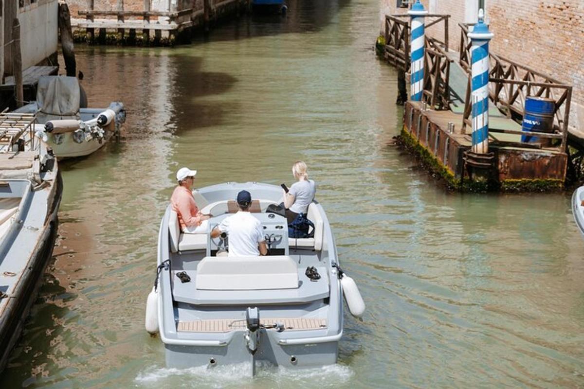 a group of people in a boat in a canal