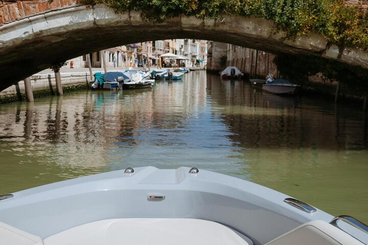 a boat in a canal with boats in the water
