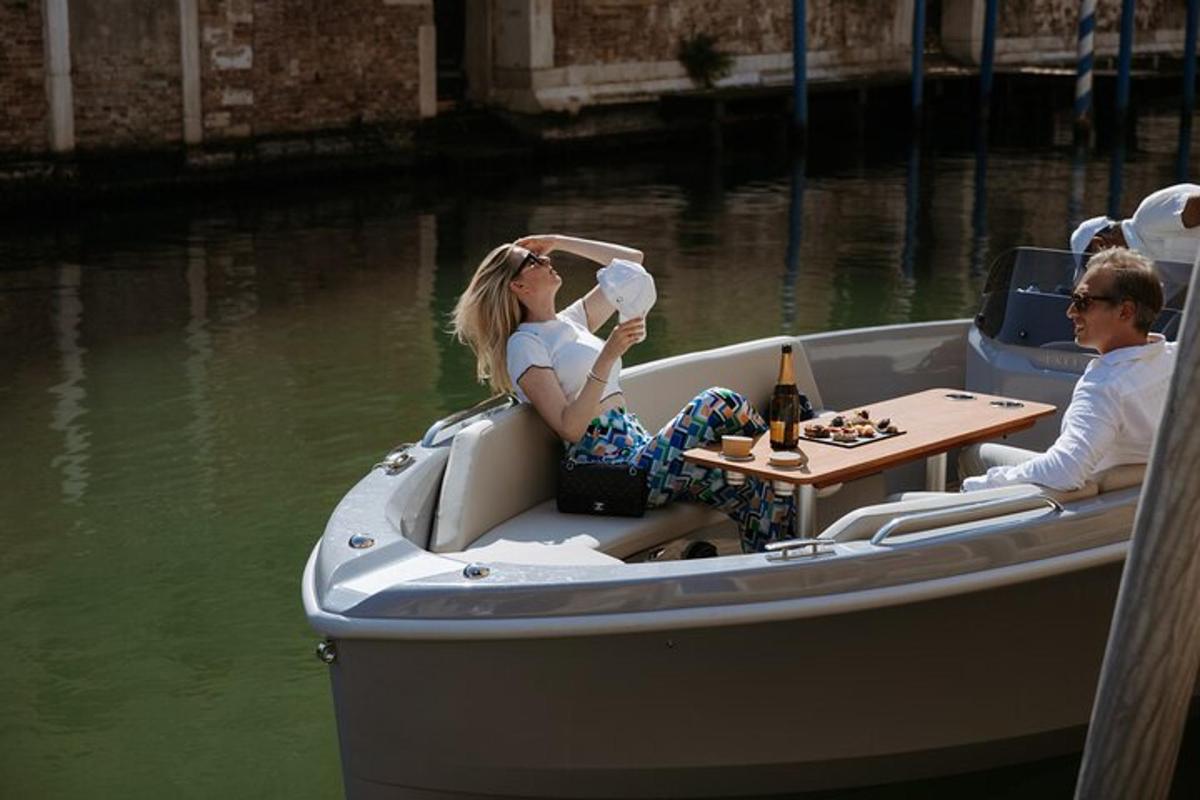 two people sitting in a boat with a table