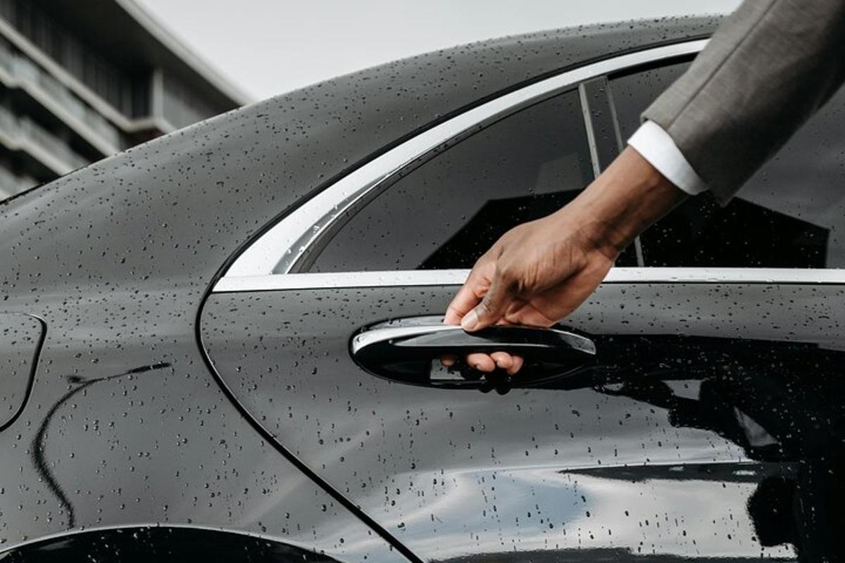 a man is opening the door of a car