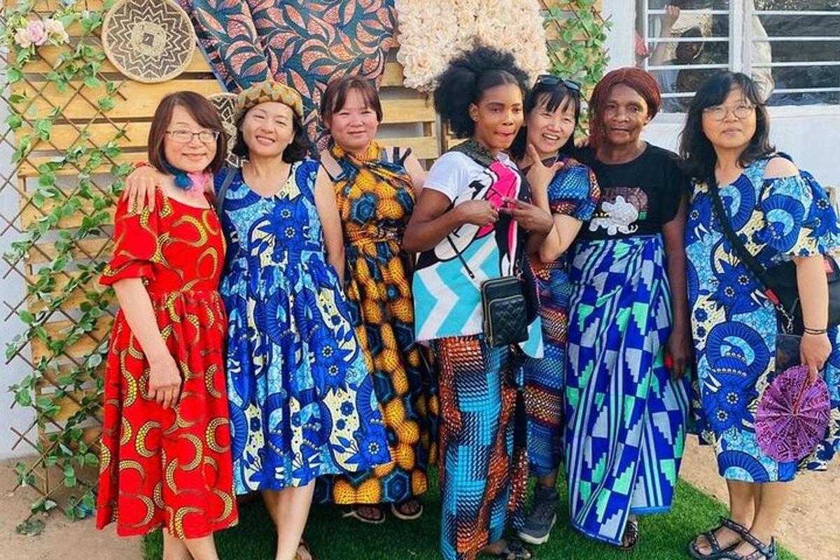 a group of women in dresses posing for a picture