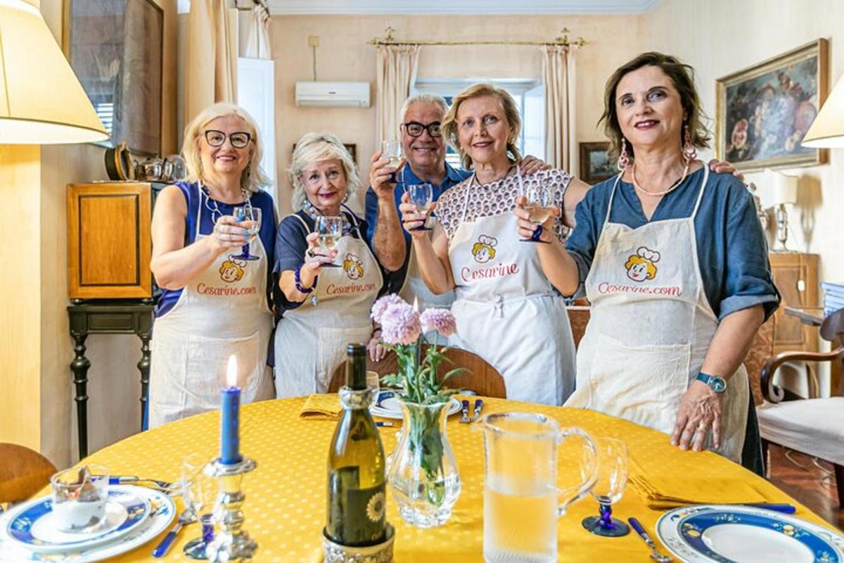 un gruppo di donne in piedi attorno a un tavolo con in mano dei bicchieri di vino