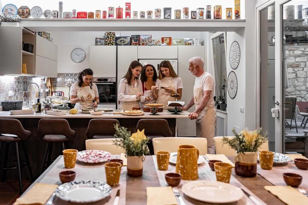 a group of people standing in a kitchen