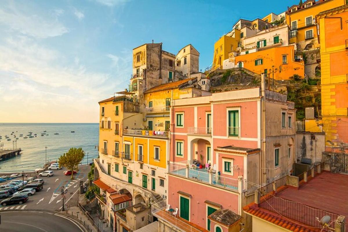 a group of buildings on a hill next to the ocean