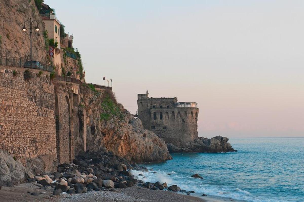 a castle on a cliff next to the ocean