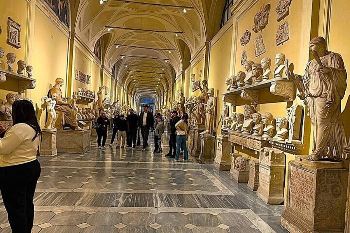 a group of people looking at statues in a museum