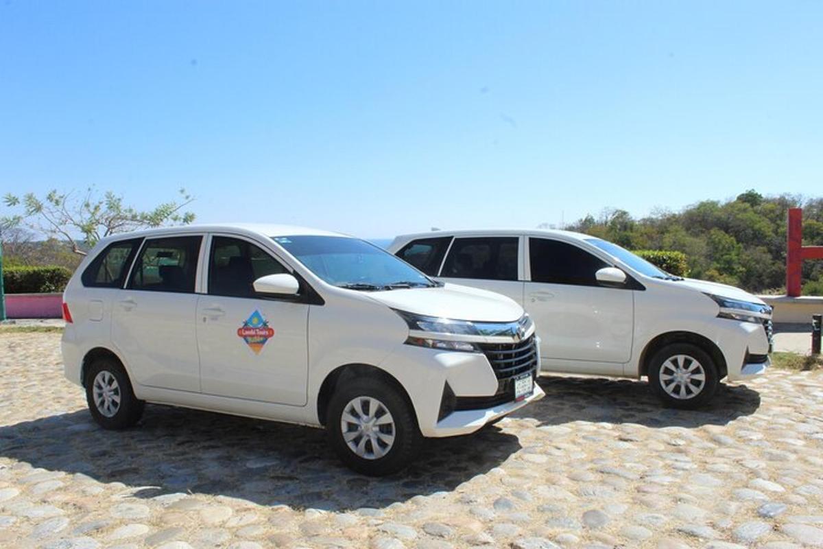 two white vehicles parked next to each other