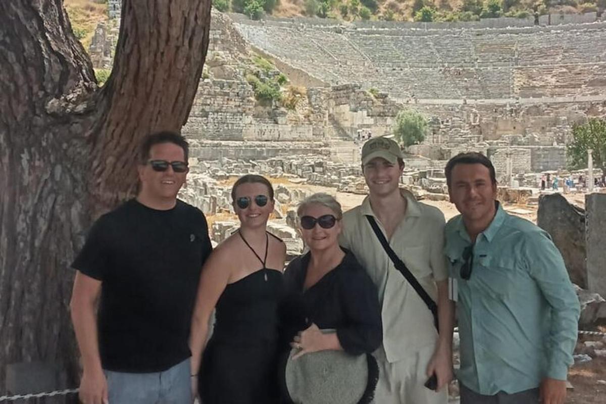 a group of people posing for a picture in front of a pyramid