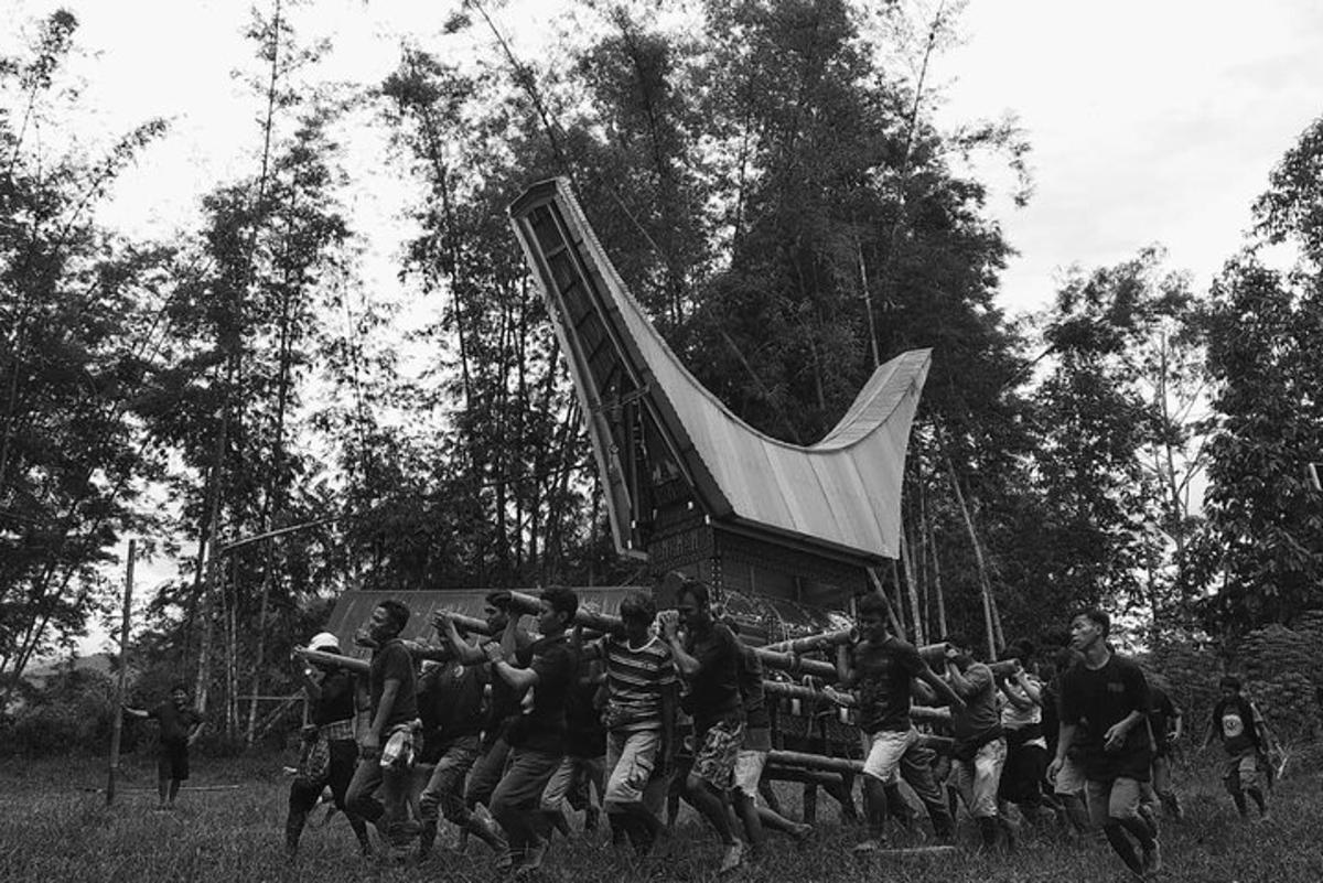 a group of men running in front of a large object
