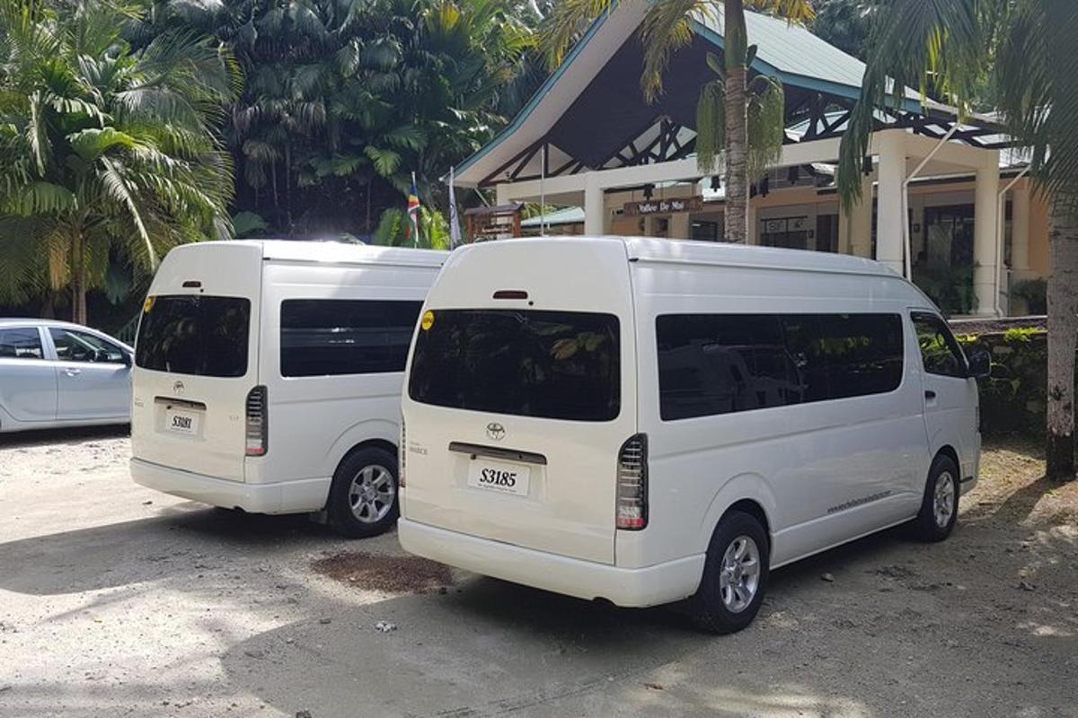two white vans parked in front of a building
