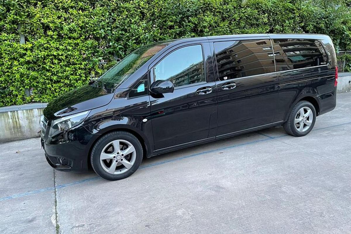 a small black van parked in a parking lot