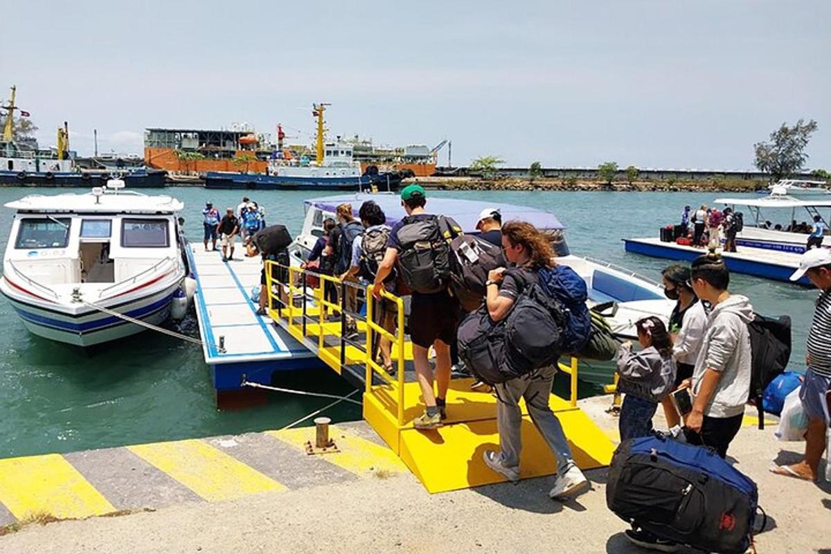a group of people getting on a boat in the water