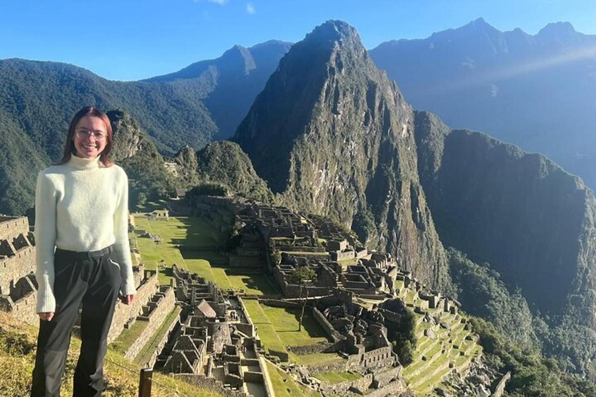 a woman standing on top of a mountain