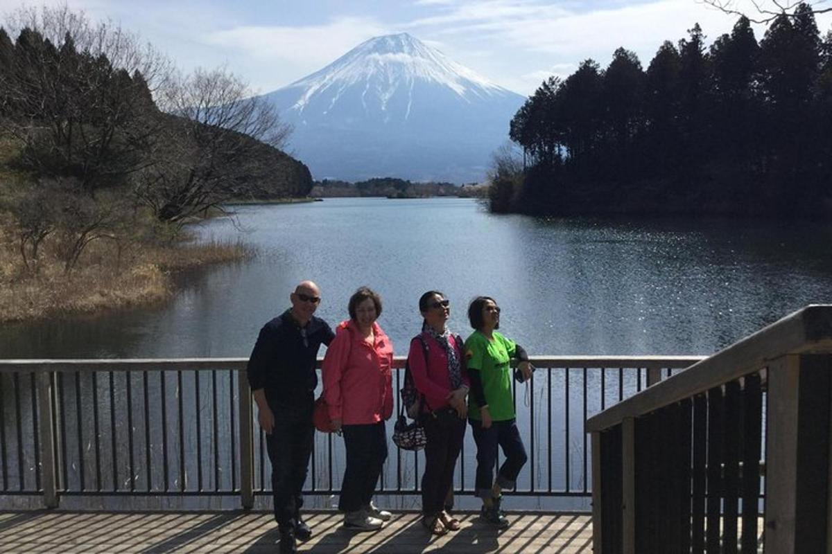 a group of people standing in front of a mountain