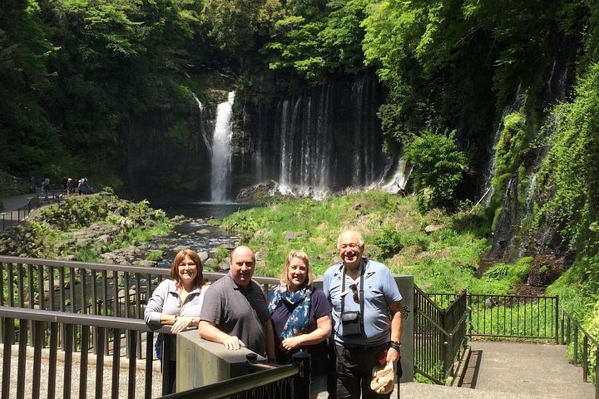 a group of people standing in front of a waterfall