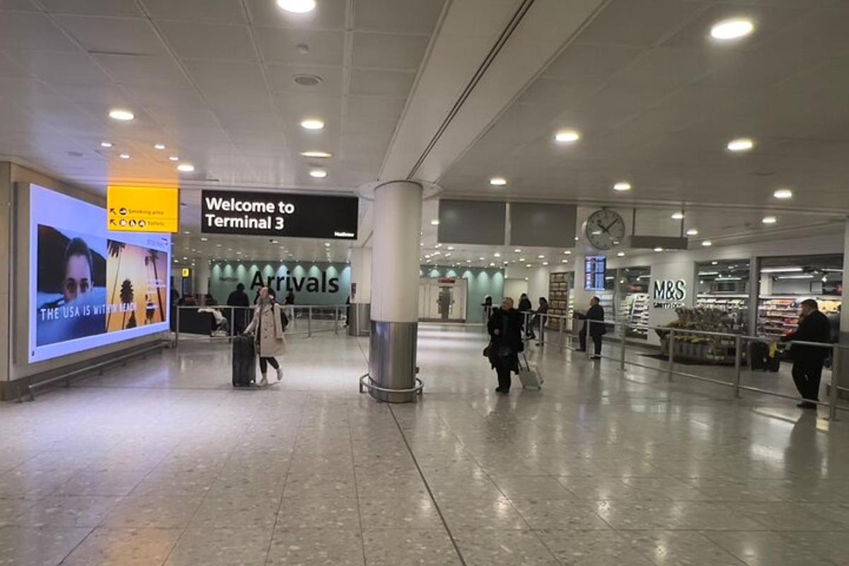 a group of people walking in an airport terminal