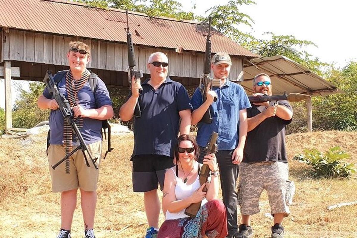 a group of people posing for a picture with guns