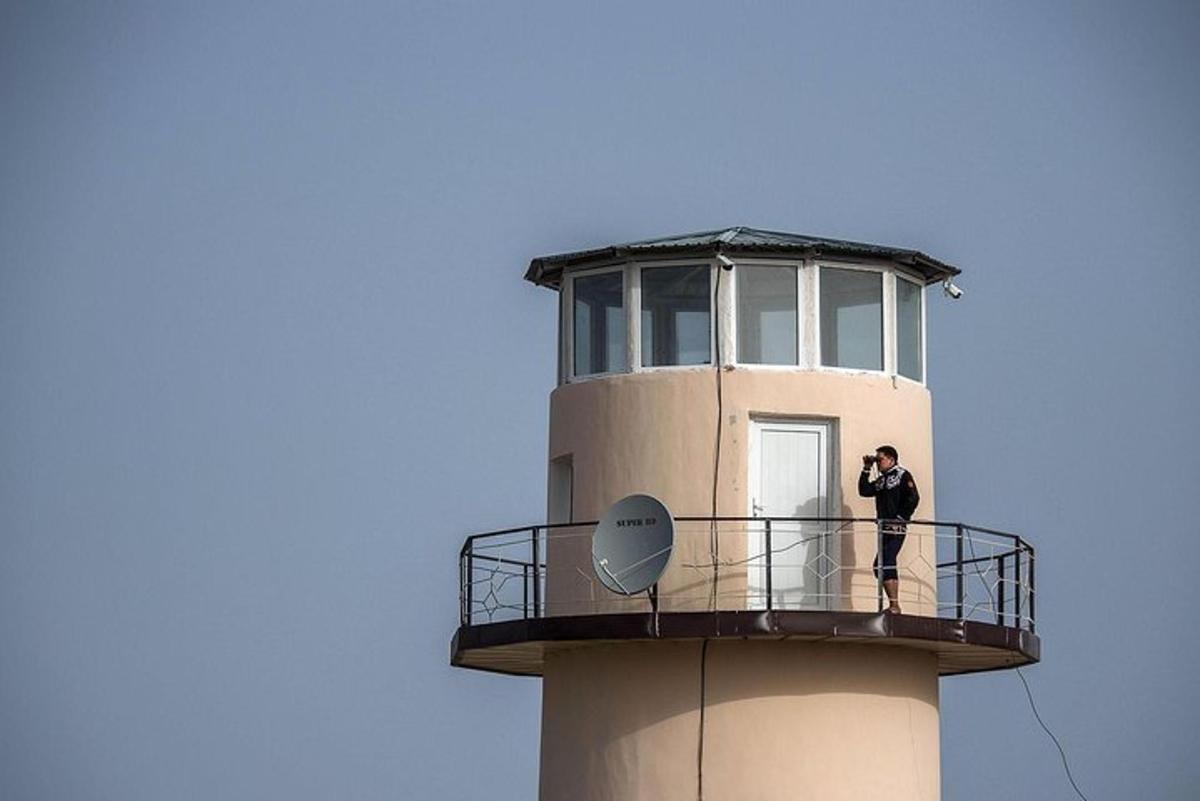 a man standing on the top of a lighthouse