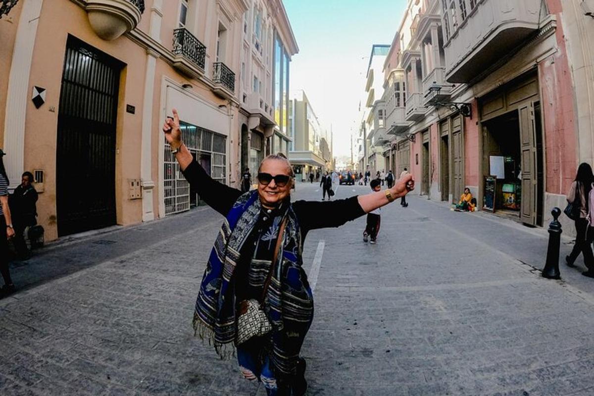 un hombre caminando por una calle con los brazos en el aire