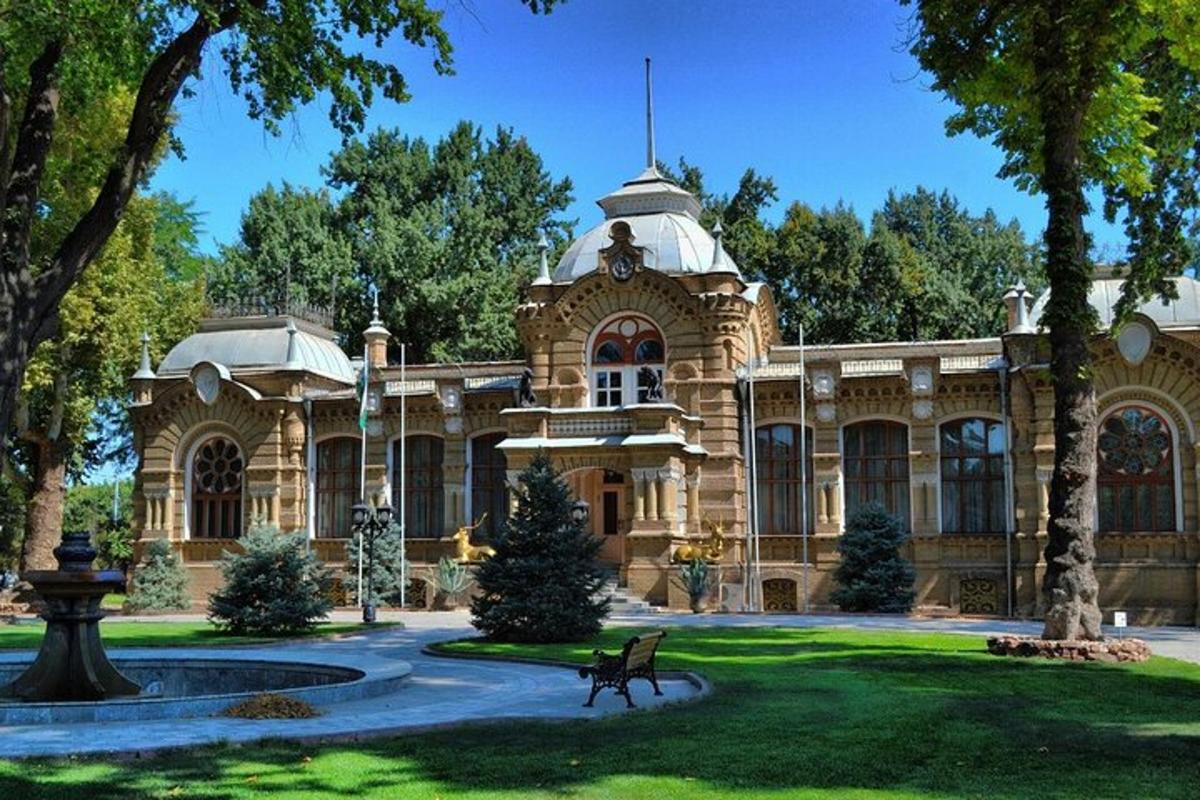 a large building with a fountain in a park