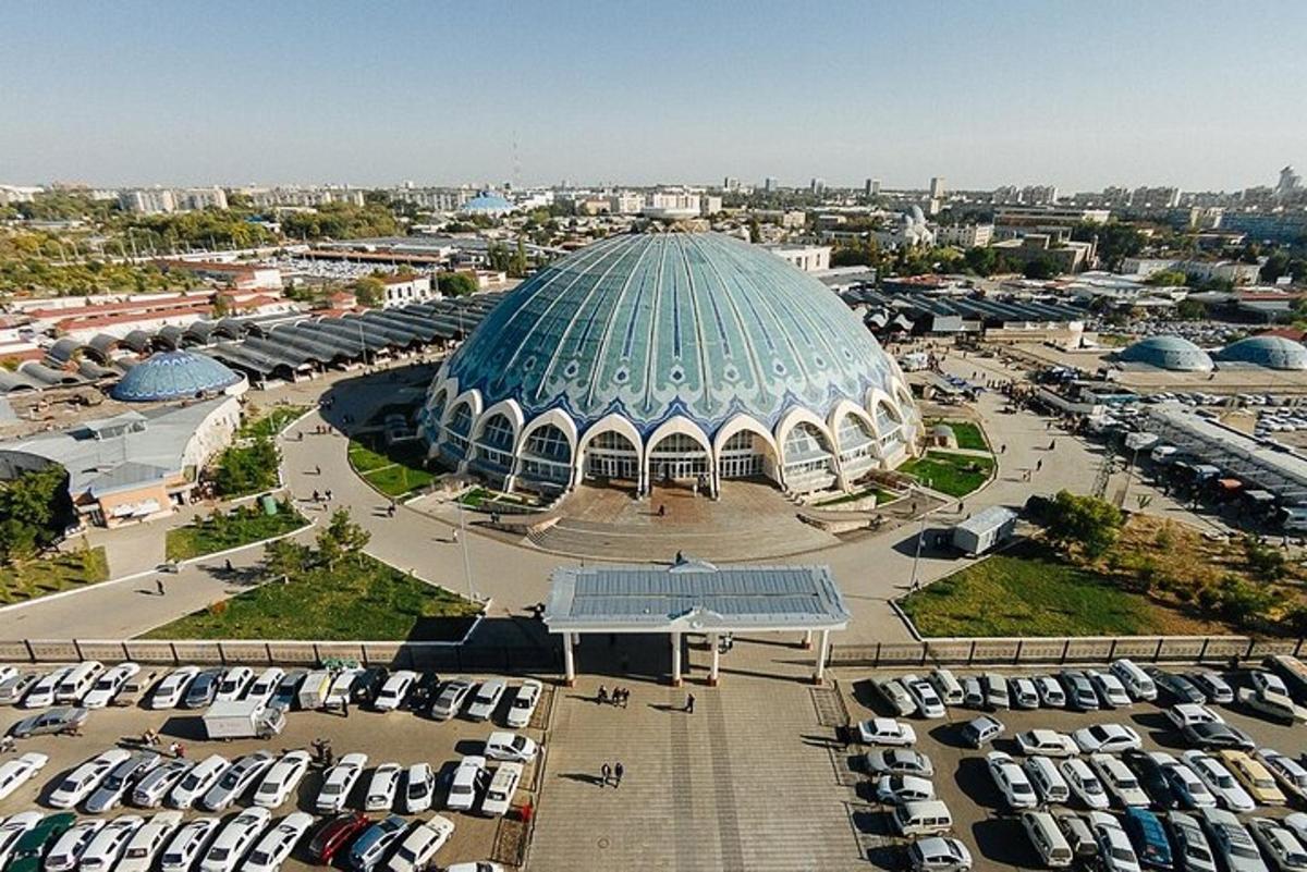 a large domed building with cars parked in a parking lot
