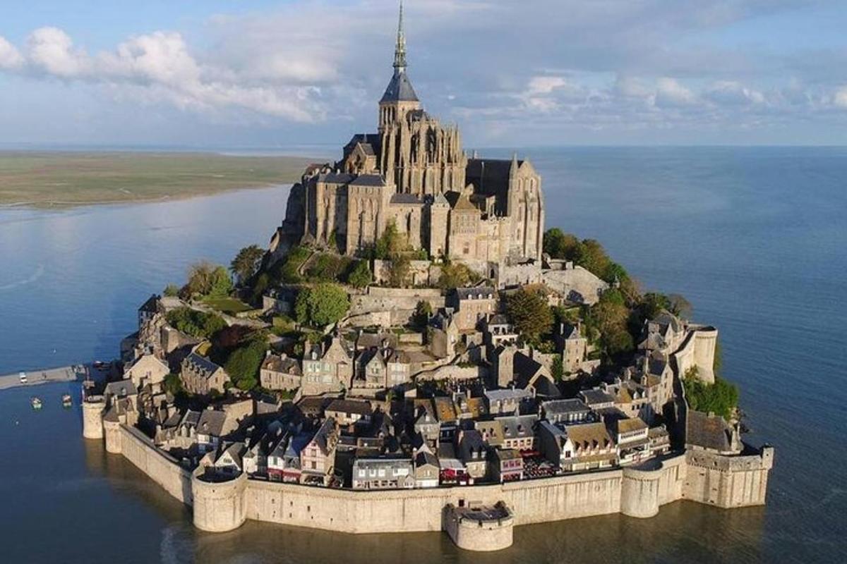 an island in the water with a large castle