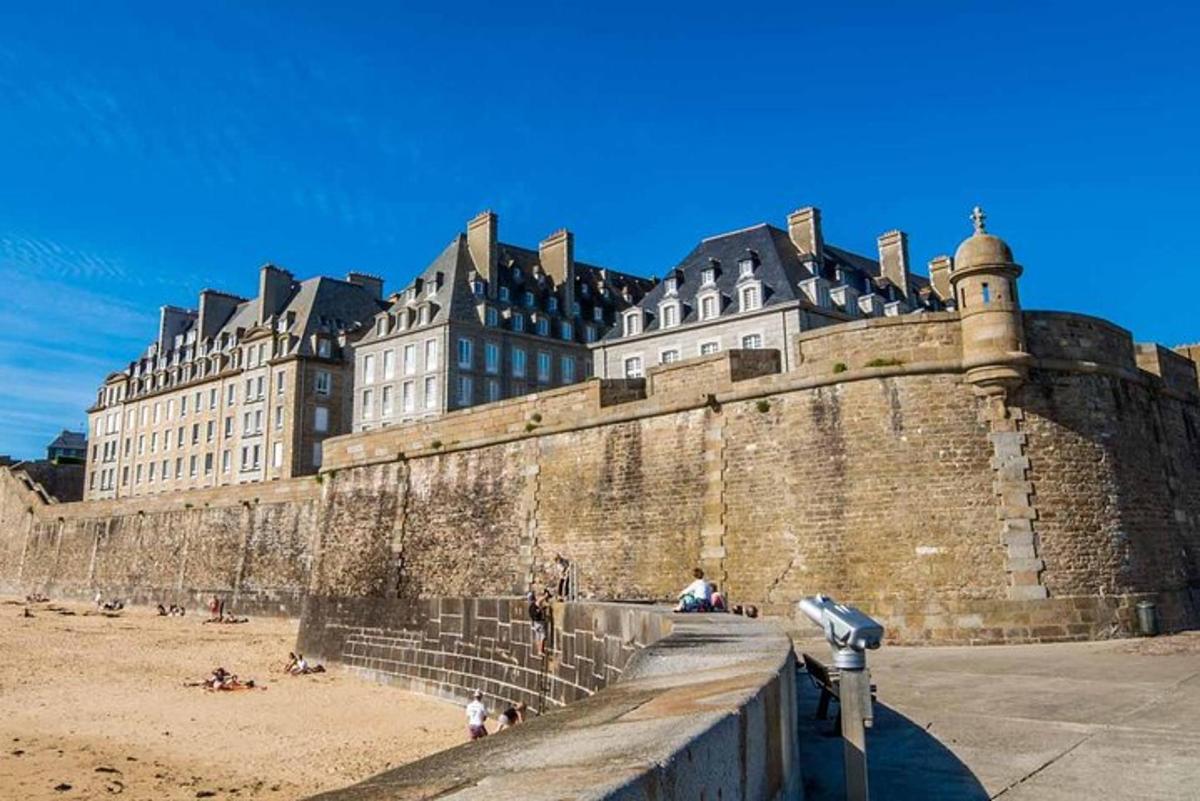 a large castle with people on the beach in front of it