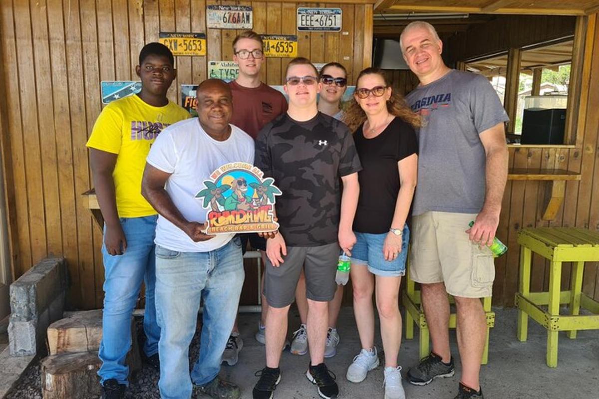a group of people posing for a picture with a cake