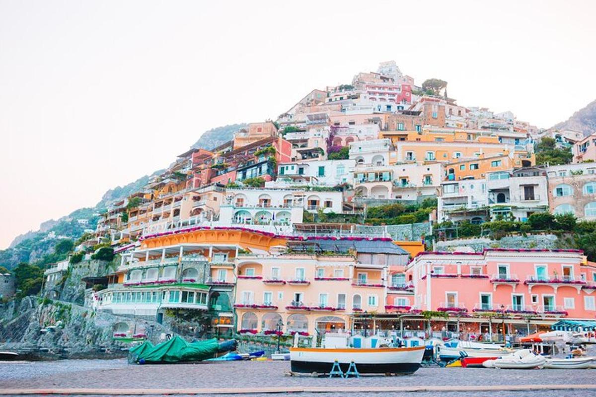 a bunch of houses on a hill with boats in the water